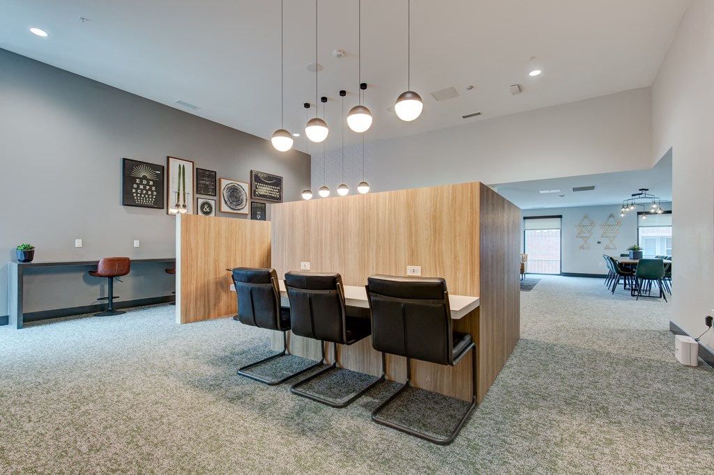 a dining room with a table and chairs in front of a wood wall