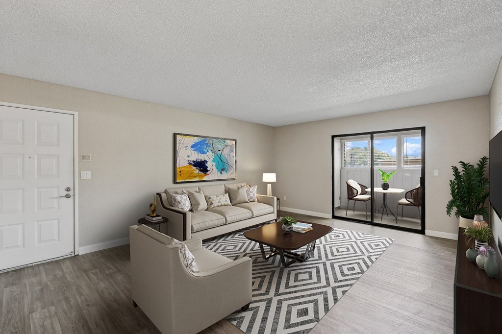 a living room with a couch and a coffee table    and a door