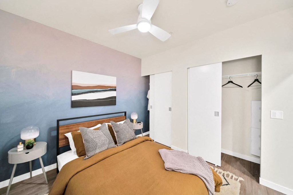 a bedroom with a bed and a ceiling fan