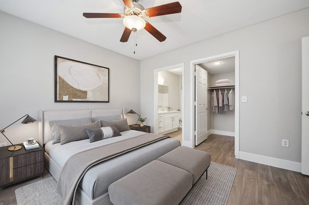 a bedroom with a large bed and a ceiling fan