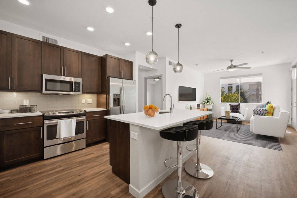 a kitchen and living room with a large white counter top