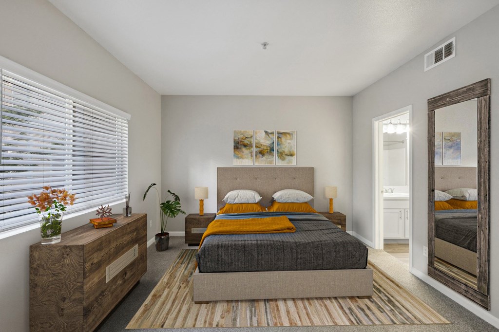 a bedroom with a bed and a mirror