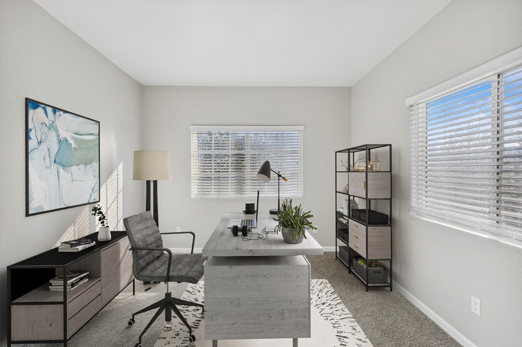 an office with a desk and a chair and a window