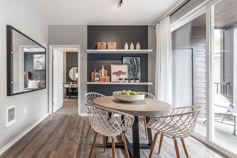 a dining room with a table and chairs and a window