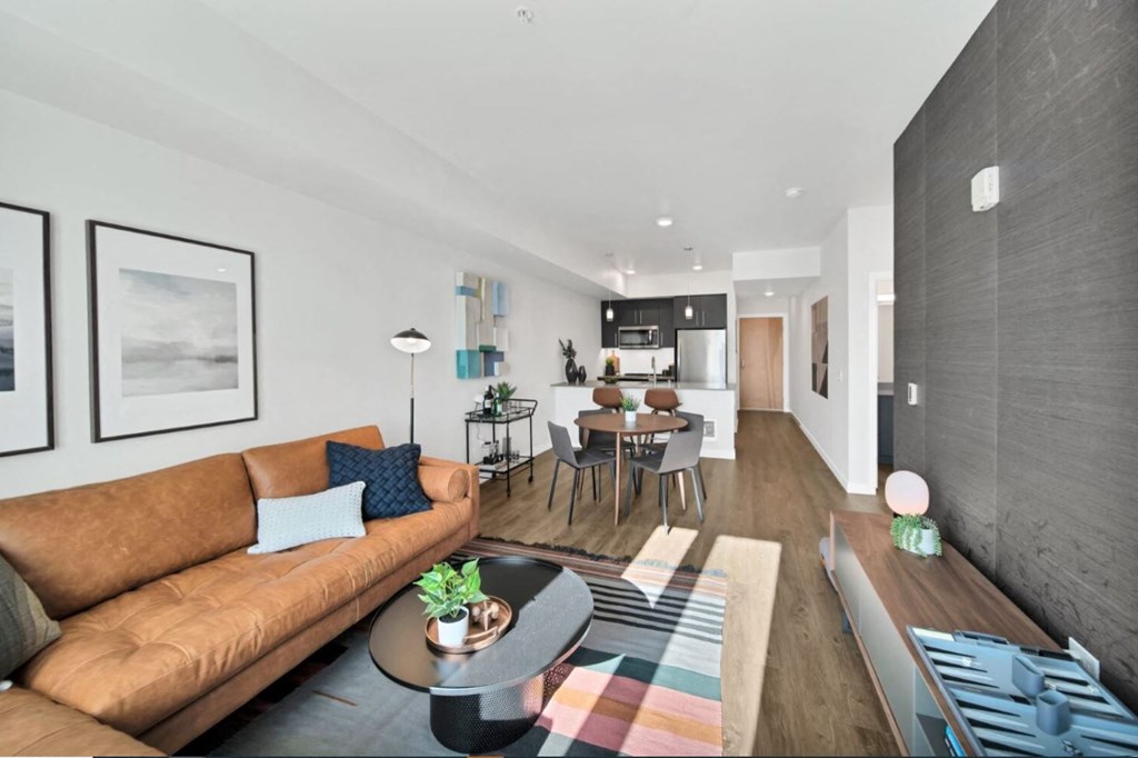 a living room with a brown couch and a table