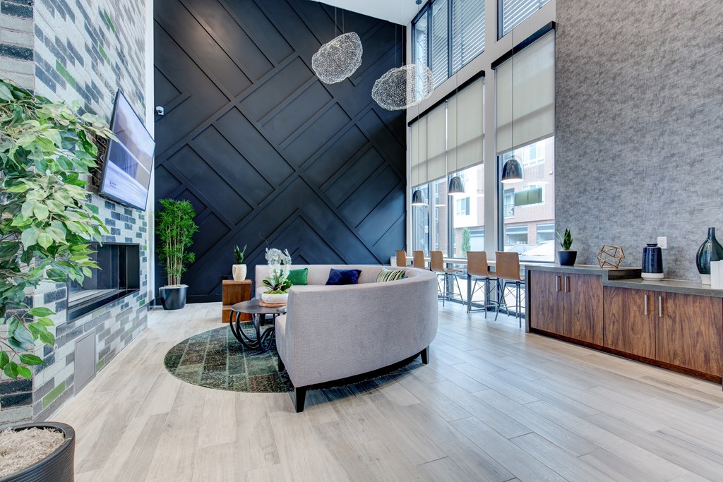 a living room with a couch and a table in front of a fireplace
