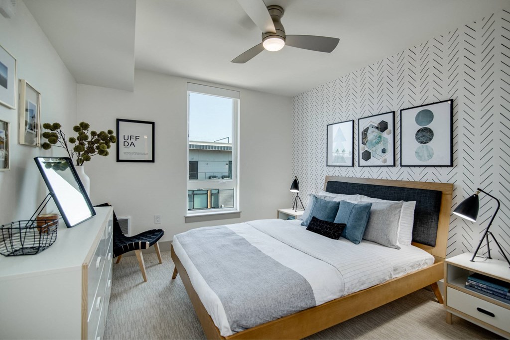 a bedroom with a large bed and a ceiling fan