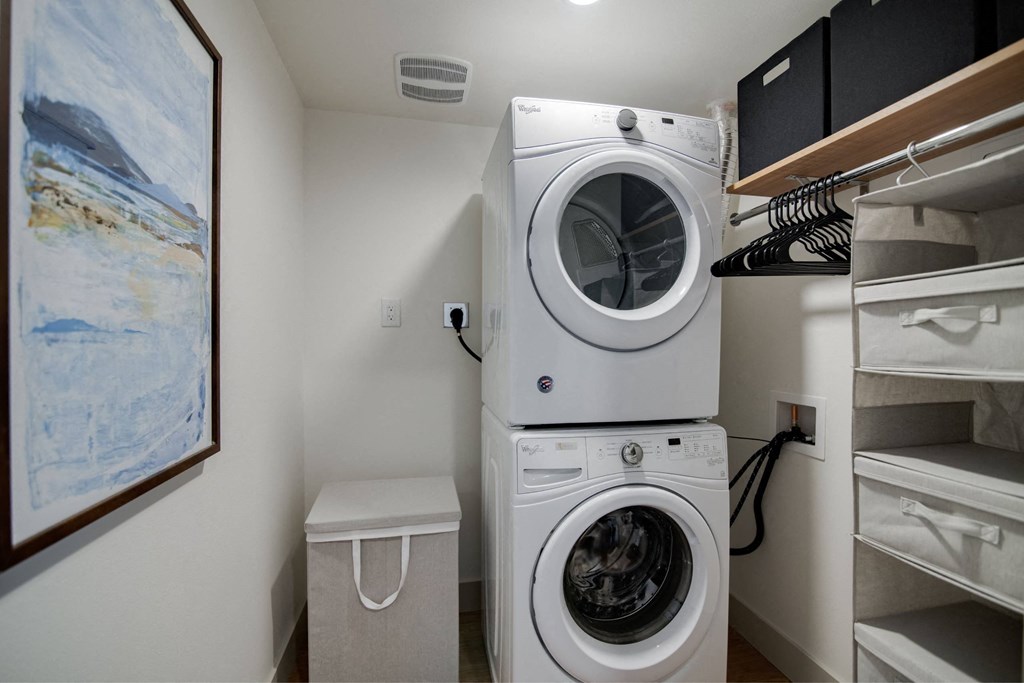 a washer and dryer in a laundry room with a closet