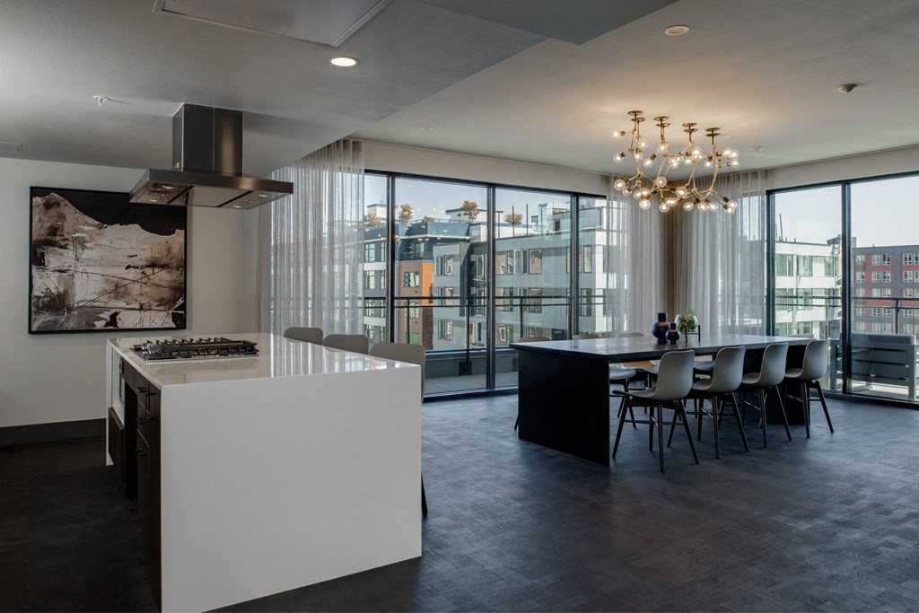 a kitchen and dining area with a large window and a table with chairs