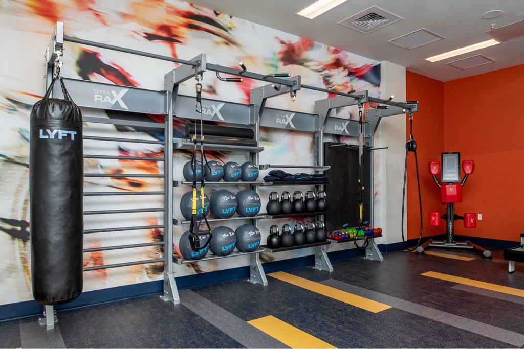 a boxing gym with boxing equipment and a mural on the wall