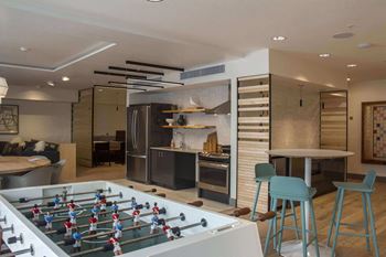 a game room with a foosball table and a bar