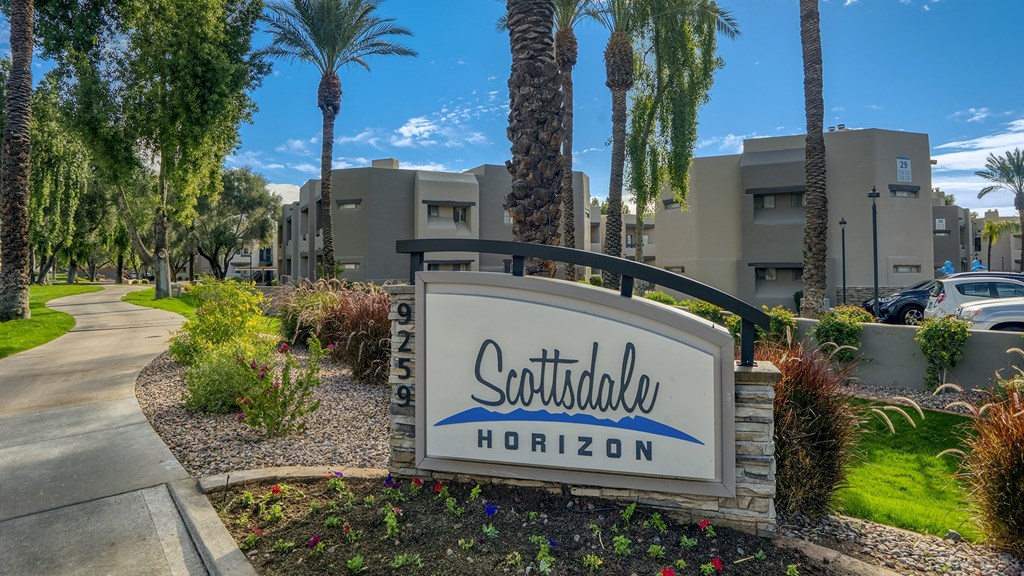 the sign at the entrance of scottsdale hotel on a tree lined street