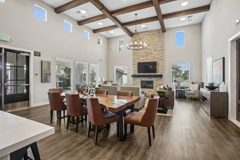 A dining room with a long table and chairs.