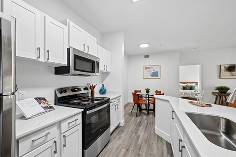 A kitchen with white cabinets and stainless steel appliances.