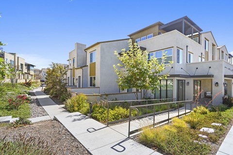 A modern house with a garden in front.