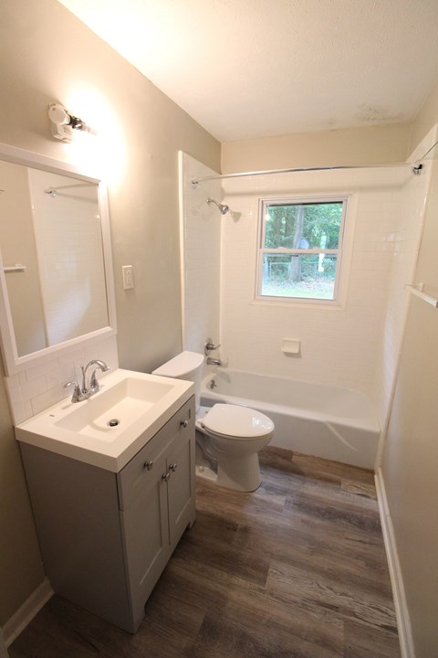 a small bathroom with a sink toilet and bath tub