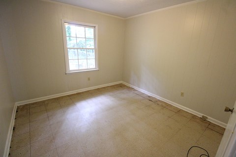 a room with a tiled floor and a window