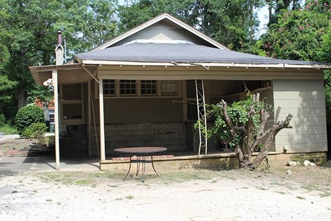 the front of a house with a table in front of it