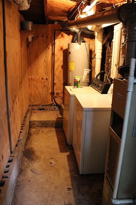 a small room with a refrigerator and a washing machine