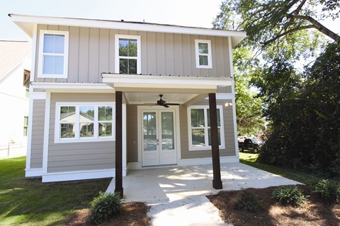 the front of the house has a walkway and a porch