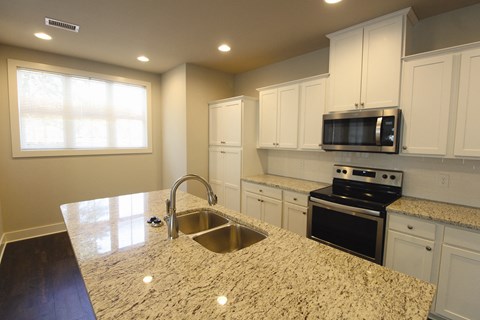 a kitchen with a granite counter top and a sink