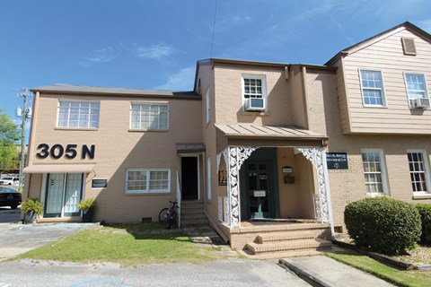 the front of a large brown house with the number 310n on it