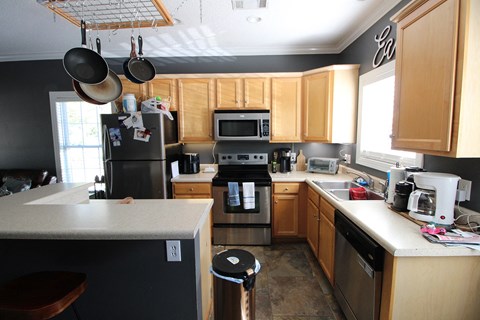 a kitchen with wooden cabinets and stainless steel appliances