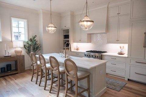 A kitchen with a white table and chairs.