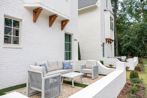 A white house with a patio set.