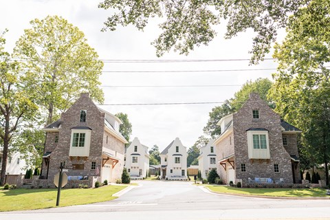 A row of houses with a road in front.