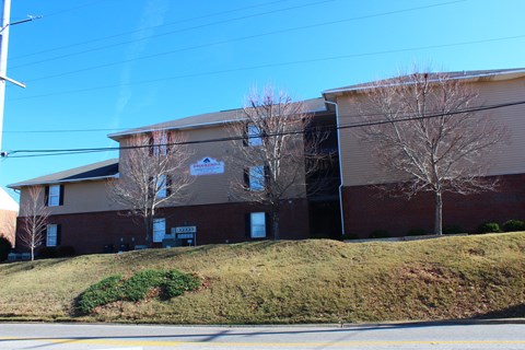 A building with a brown and beige exterior and a sign that says "The Reserve".
