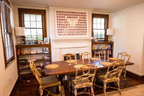 A dining room with a wooden table and chairs.
