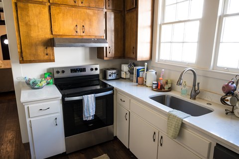 A kitchen with a white dishwasher and a black oven.