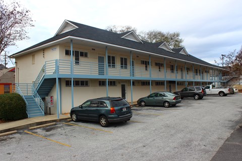 A parking lot with a building in the background.