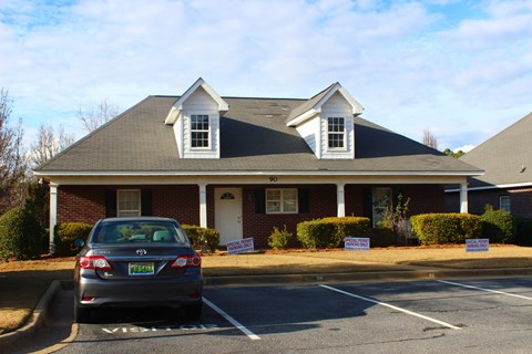 a car parked in a parking lot in front of a house