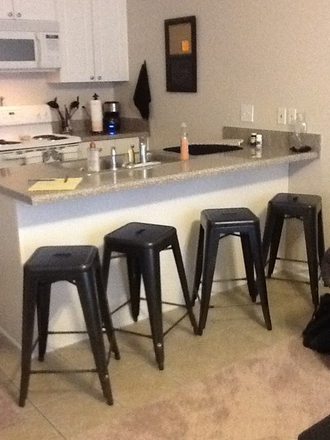 a kitchen with bar stools and a counter top