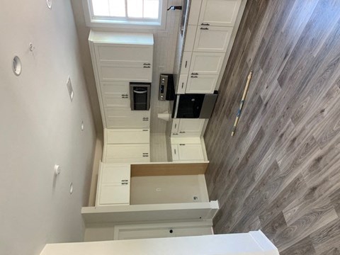 the stairwell in the center of a white room with a wood floor
