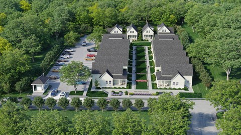A large, well-manicured estate with a large house and a parking lot.