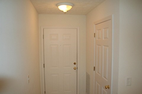 A white door with a light above it.