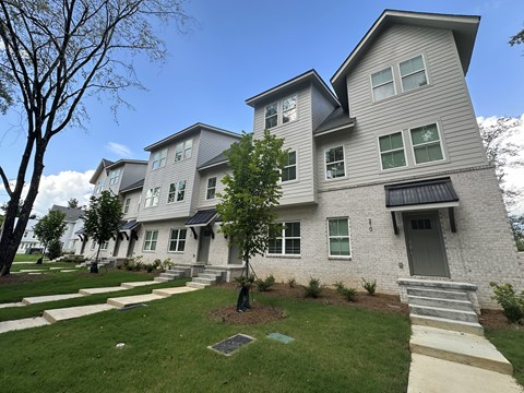 A modern two-story house with a grey and white exterior.