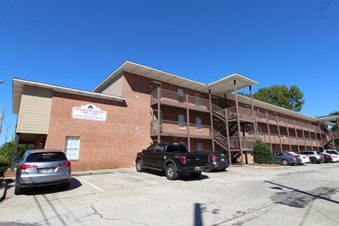 A building with a parking lot in front of it.
