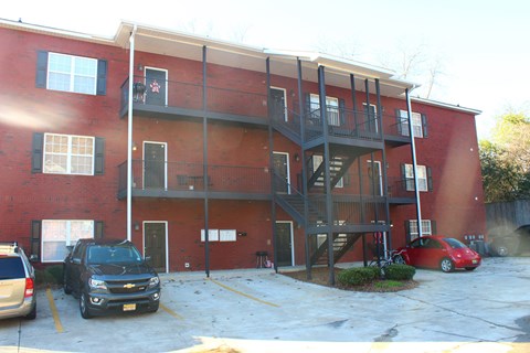 an apartment building with cars parked in front of it