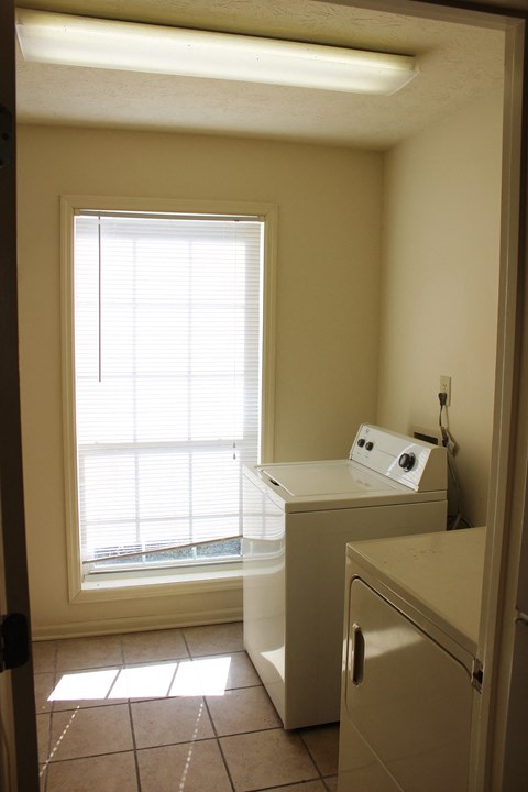 a kitchen with a large window and a refrigerator and a sink