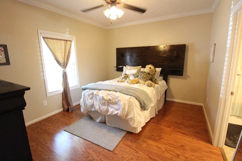 a bedroom with a bed and a ceiling fan