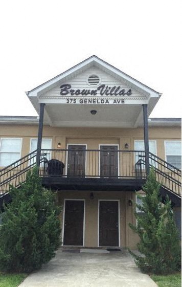 a building with a balcony and a sign on it