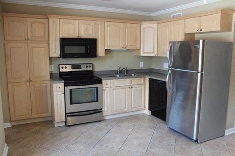 a kitchen with stainless steel appliances and wooden cabinets