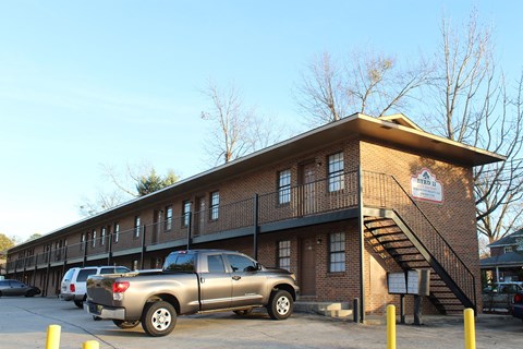 an apartment building with a truck parked in front of it