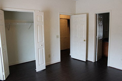 an empty living room with two doors and a closet