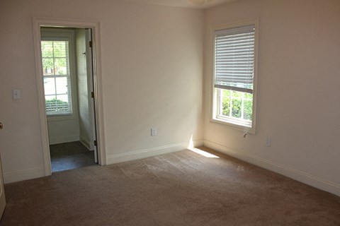 an empty room with a door and a window