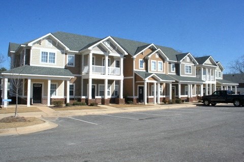 A row of houses with a truck parked in front.
